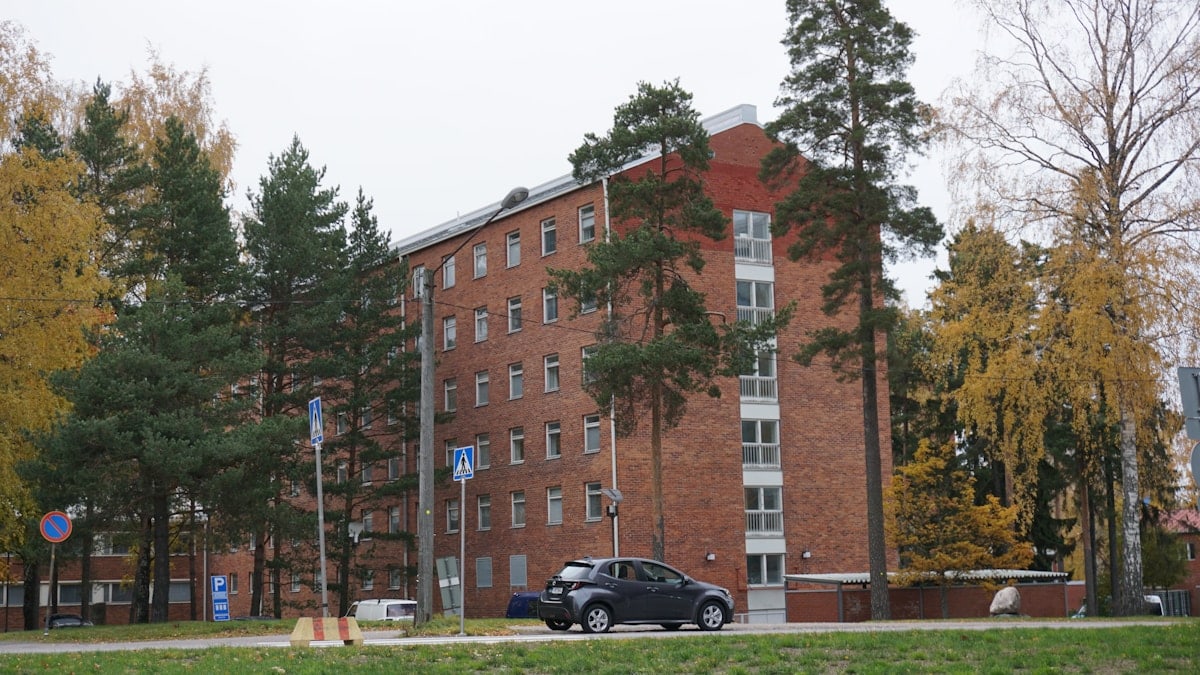 a car is parked in front of a brick building