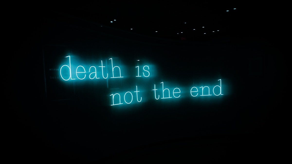 a neon sign that reads death is not the end